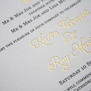 Letterpress wedding invitation printed in black and gold